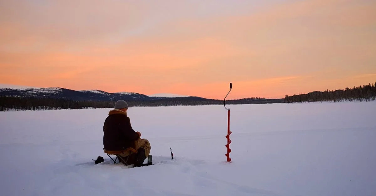 a man try to catch in ice fishing
