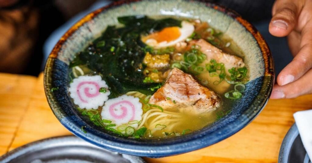 Authentic Japanese fish cake ramen in a rustic blue bowl