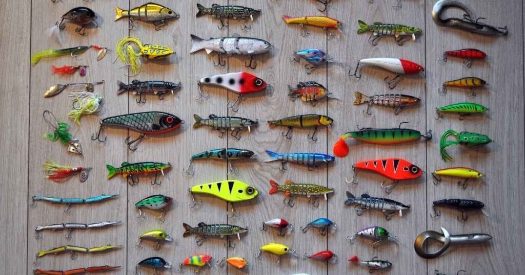 Fishing Bait | How to Pick the Right Bait for Every Fish A wide variety of colorful artificial fishing baits for fishing, laid out on a flat surface.